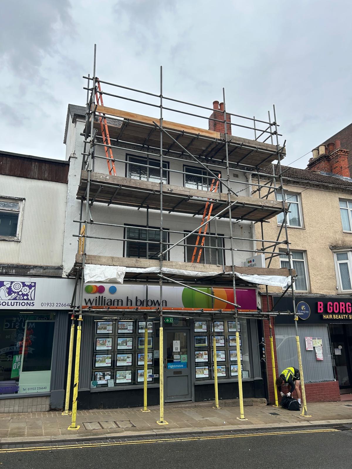 Scaffolding across a shopfront and its upper floors
